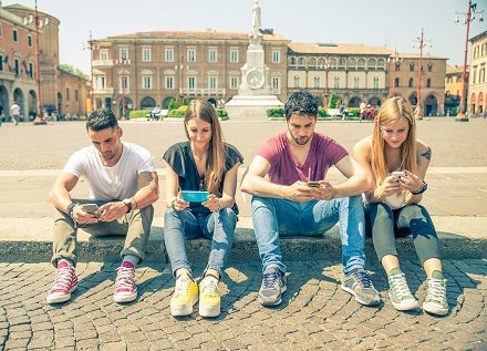 Friends texting with smartphones